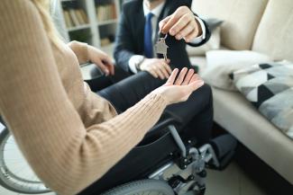Image of person with a disability receiving keys 